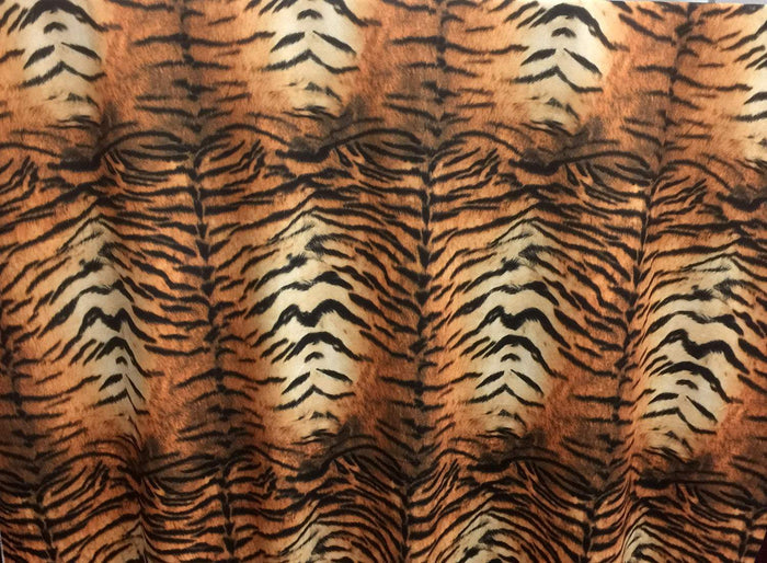 Fabric with tiger stripe pattern in brown, black, and beige.