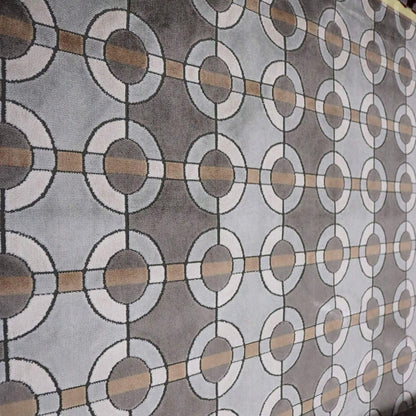 Patterned fabric with circular and rectangular shapes in gray, brown, and white.