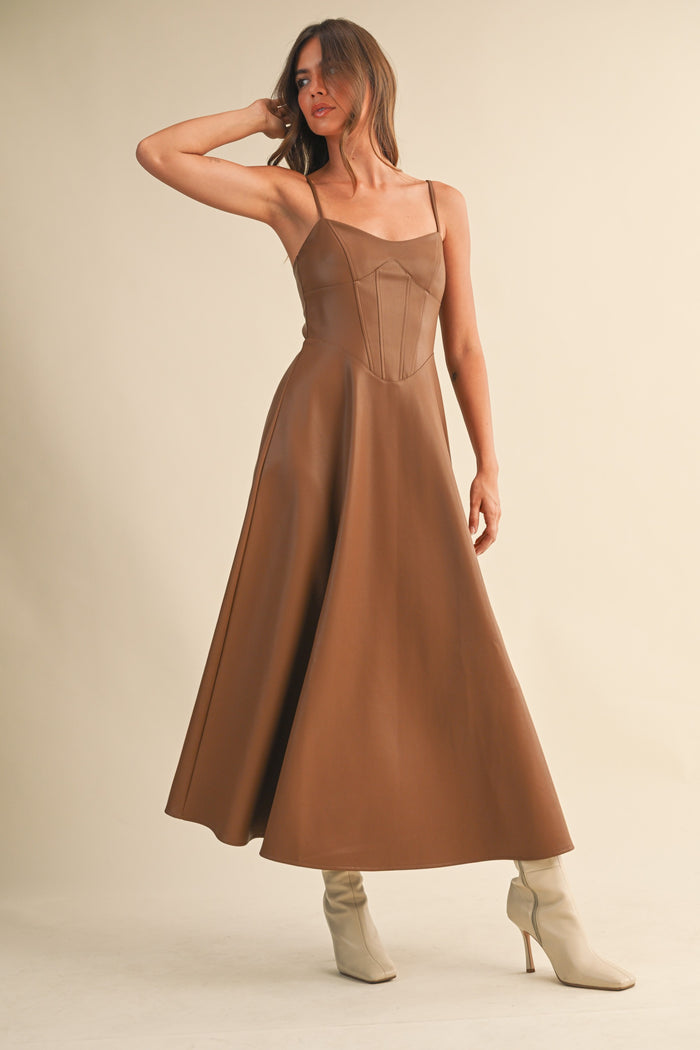 Model facing forward wearing brown Faux Leather Corset Midi Dress with relaxed posture.