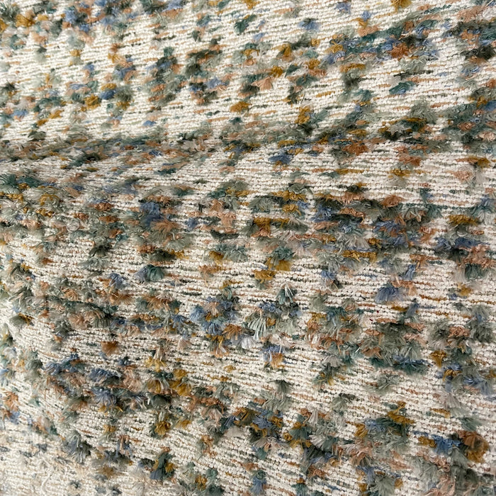 Textured fabric with a neutral color palette featuring beige, brown, and gray.