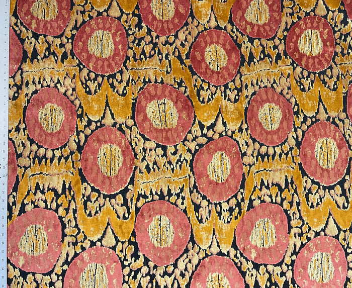 Patterned fabric with red and gold circles on a black background
