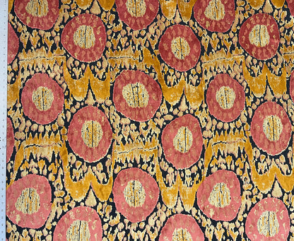 Patterned fabric with red and gold circles on a black background