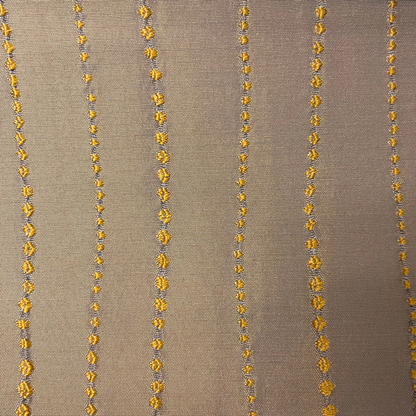 Decorative fabric with gold floral patterns on a beige background