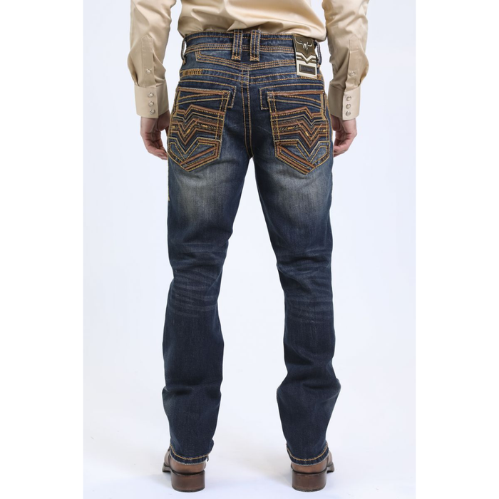 Back view of model wearing Platini Holt Dark Stone Slim Boot Cut Jeans with embroidered pockets.