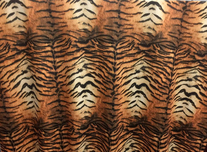 Fabric with tiger stripe pattern in brown, black, and beige.